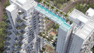 Two skyscrapers joined by a bridge that is a swimming pool